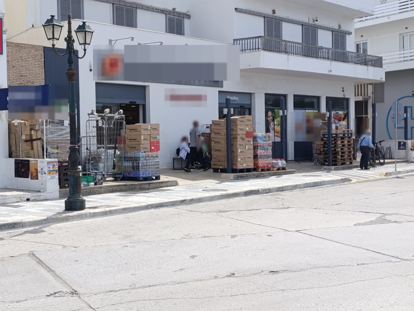 Κιβώτια και παλέτες στοιβαγμένα μπροστά στην πρόσοψη καταστήματος