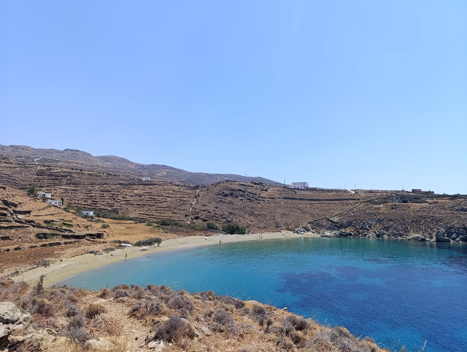 Η παραλία της Απηγανιάς με τα σπίτια στην πλαγιά και τον δρόμο