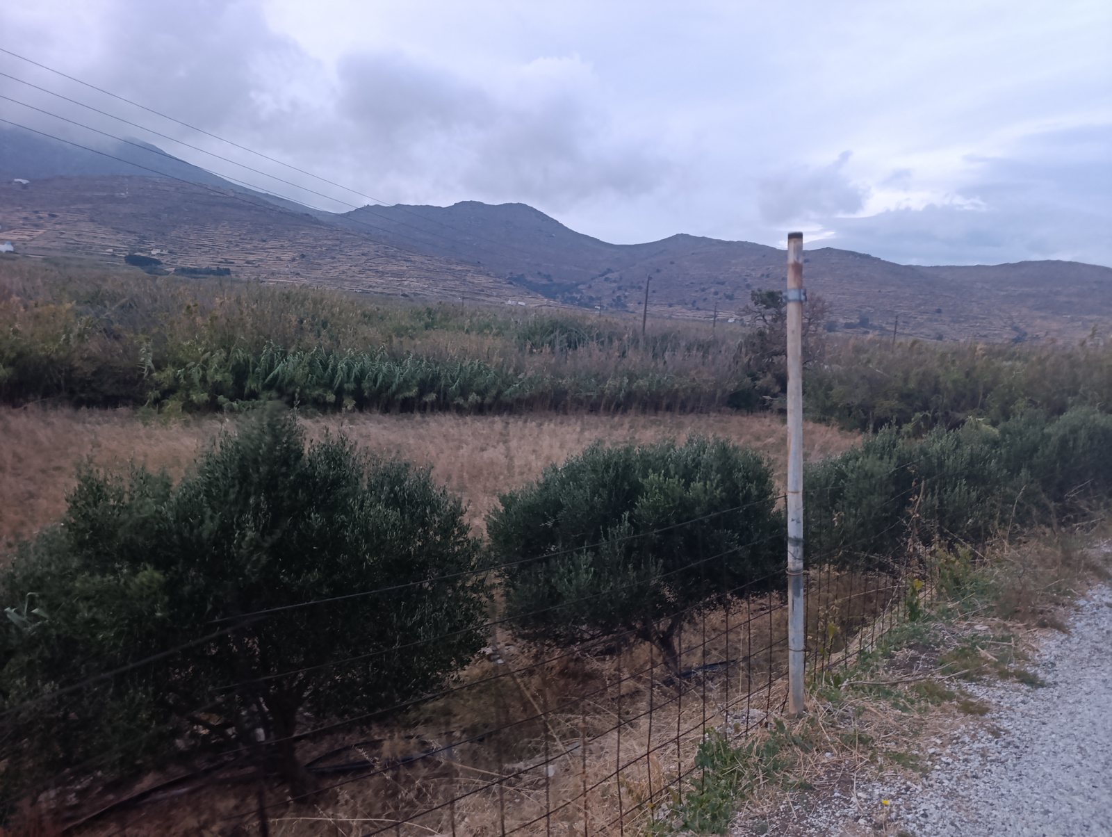 Μεταλλικός στύλος χωρίς καθρέφτη στην άκρη του δρόμου στην Καρμανιόλα της Τήνου