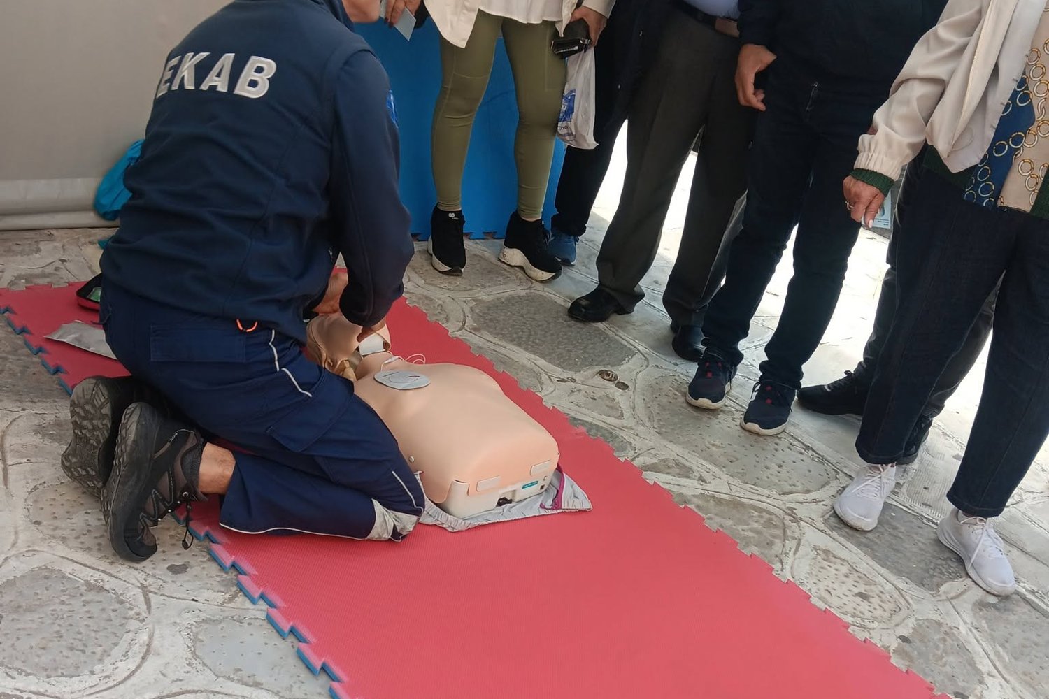 Διασώστης του ΕΚΑΒ Τήνου δείχνει στους πολίτες τις θωρακικές συμπιέσεις σε πρόπλασμα
